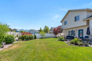 Expansive backyard featuring a manicured lawn and mature landscaping