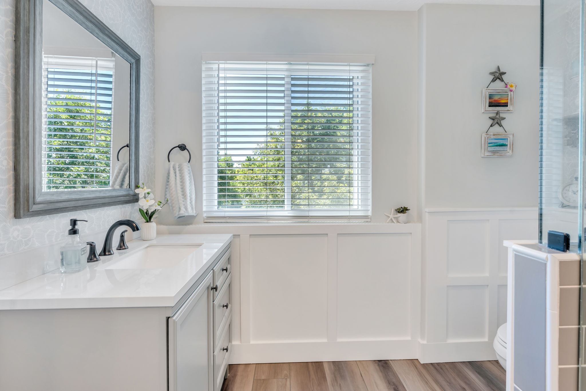 Bathroom vanity with a rectangular undermount sink, quartz countertop, and matte black faucet