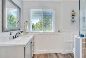 Bathroom vanity with a rectangular undermount sink, quartz countertop, and matte black faucet