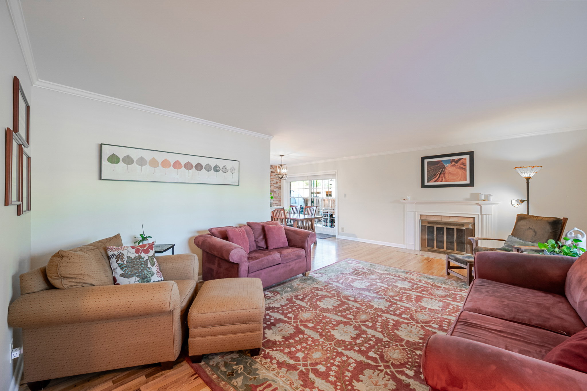 Living room featuring newly refinished hardwood flooring and a fireplace