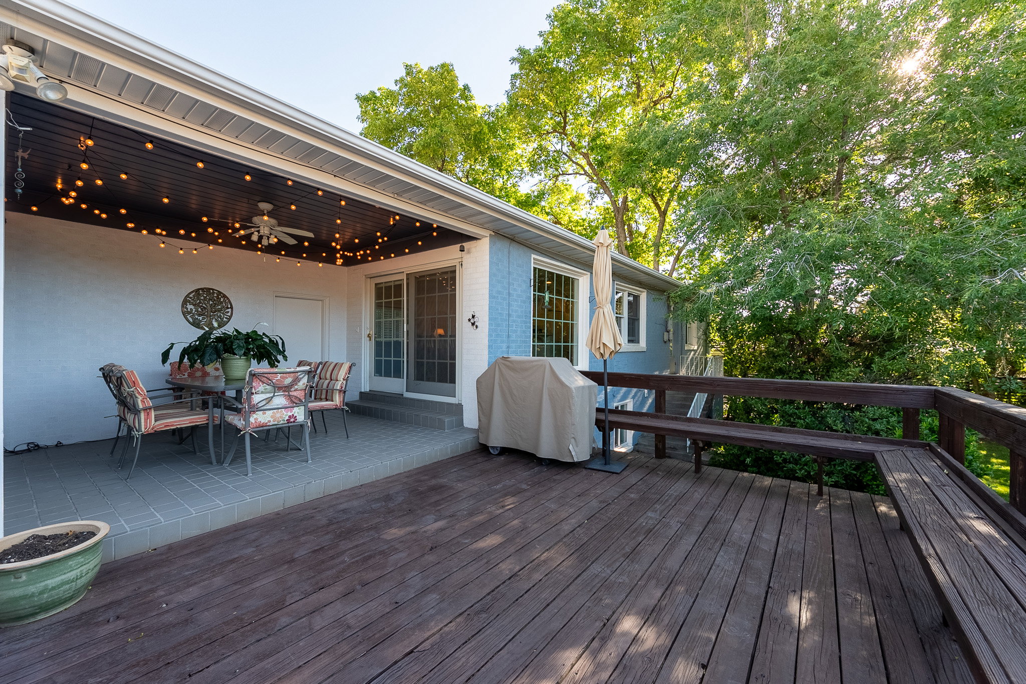 Cozy wood deck with built-in seating, featuring a covered patio area