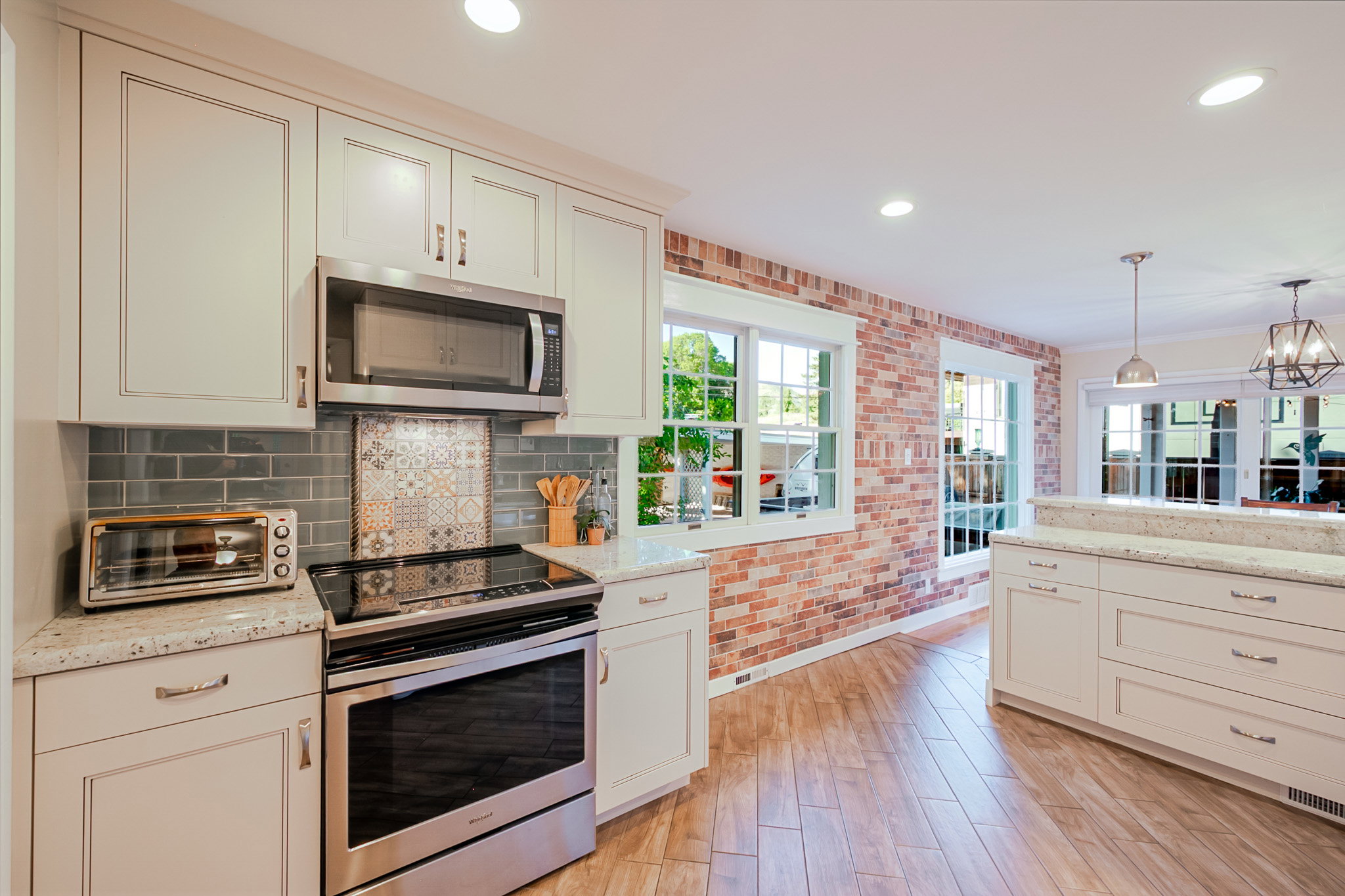 Contemporary kitchen featuring white cabinetry, stainless steel appliances