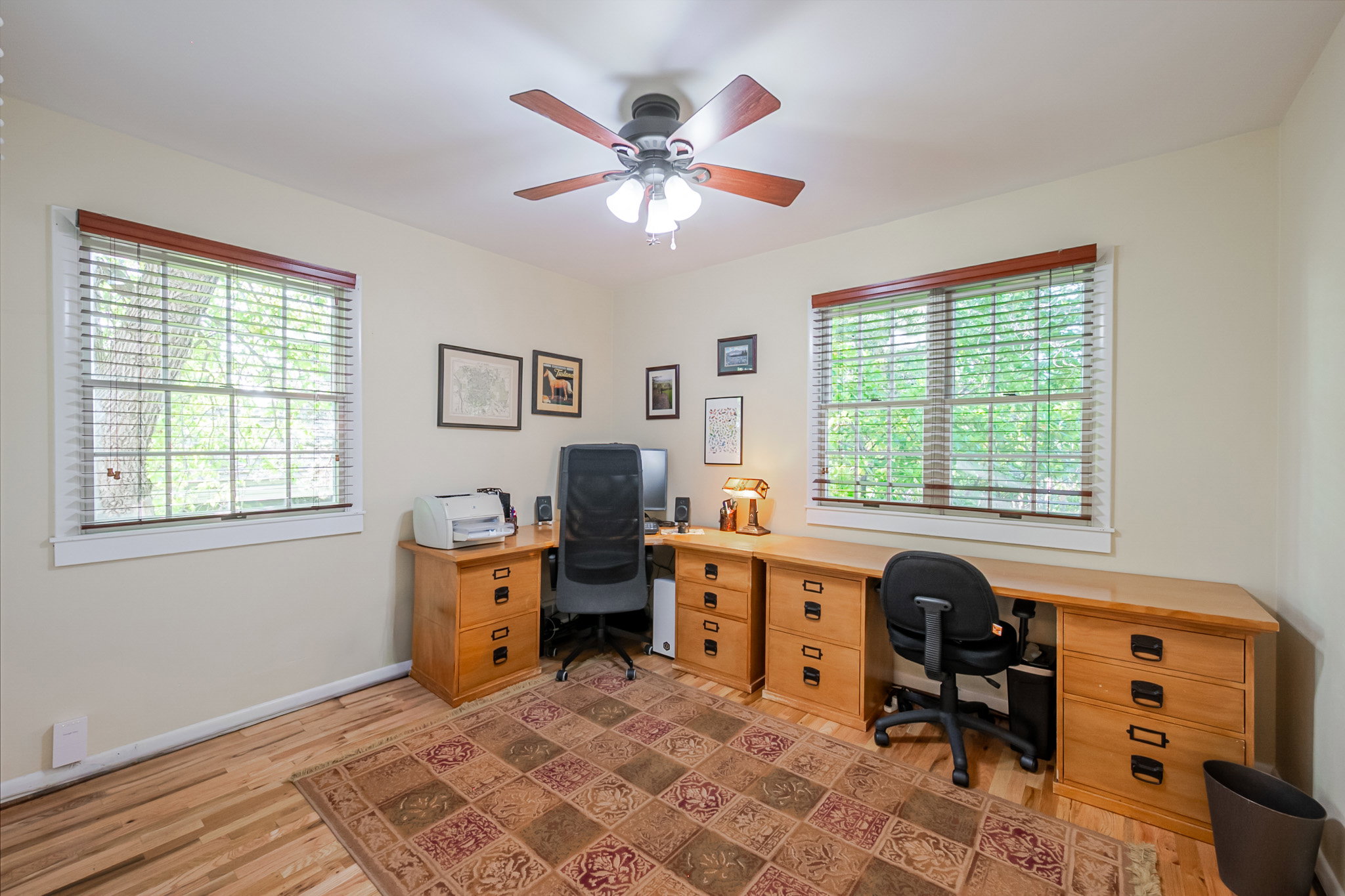 Second main floor Bedroom featuring light hardwood flooring and large windows