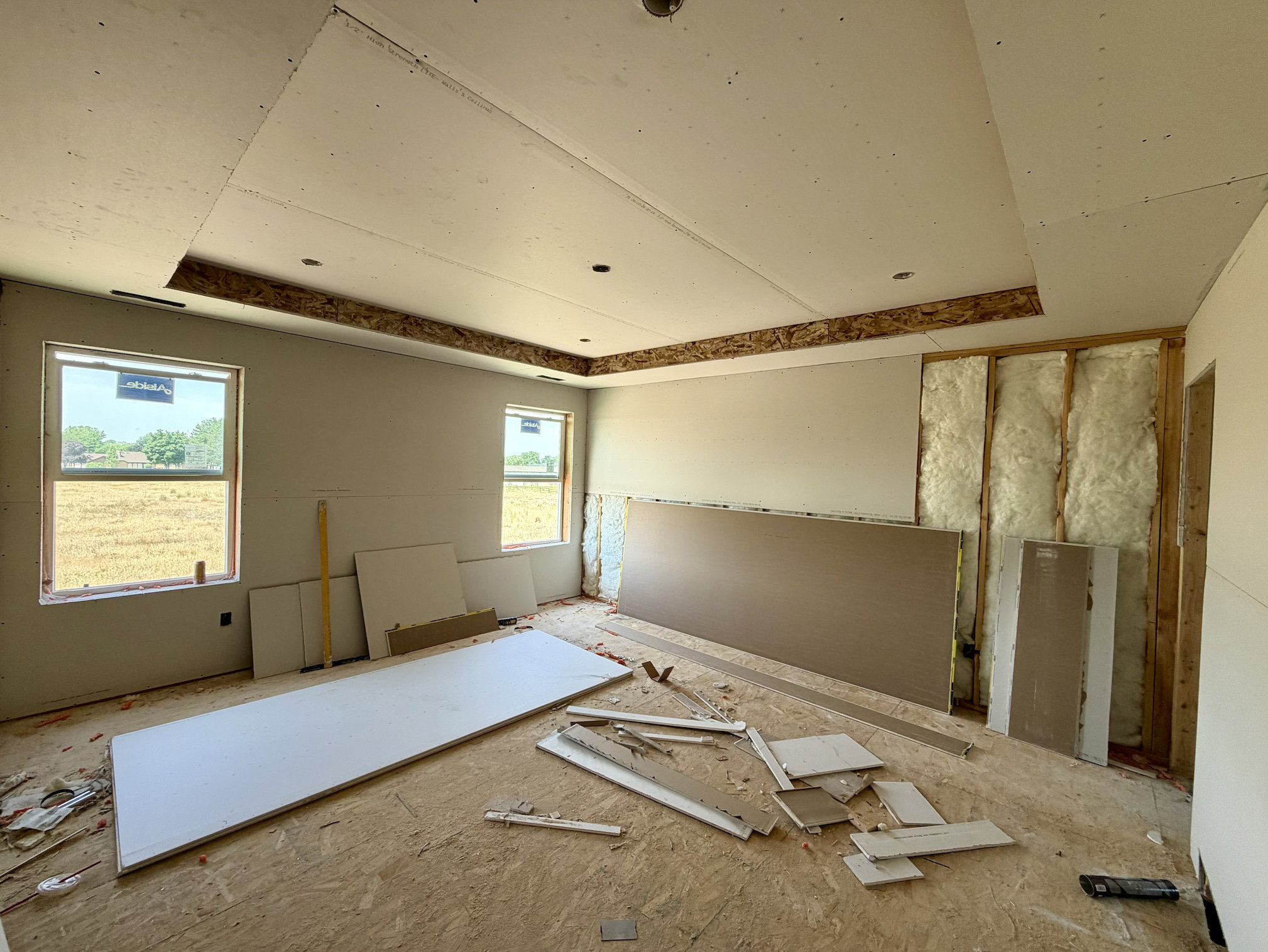 Unfinished interior space featuring a tray ceiling with recessed lighting capability