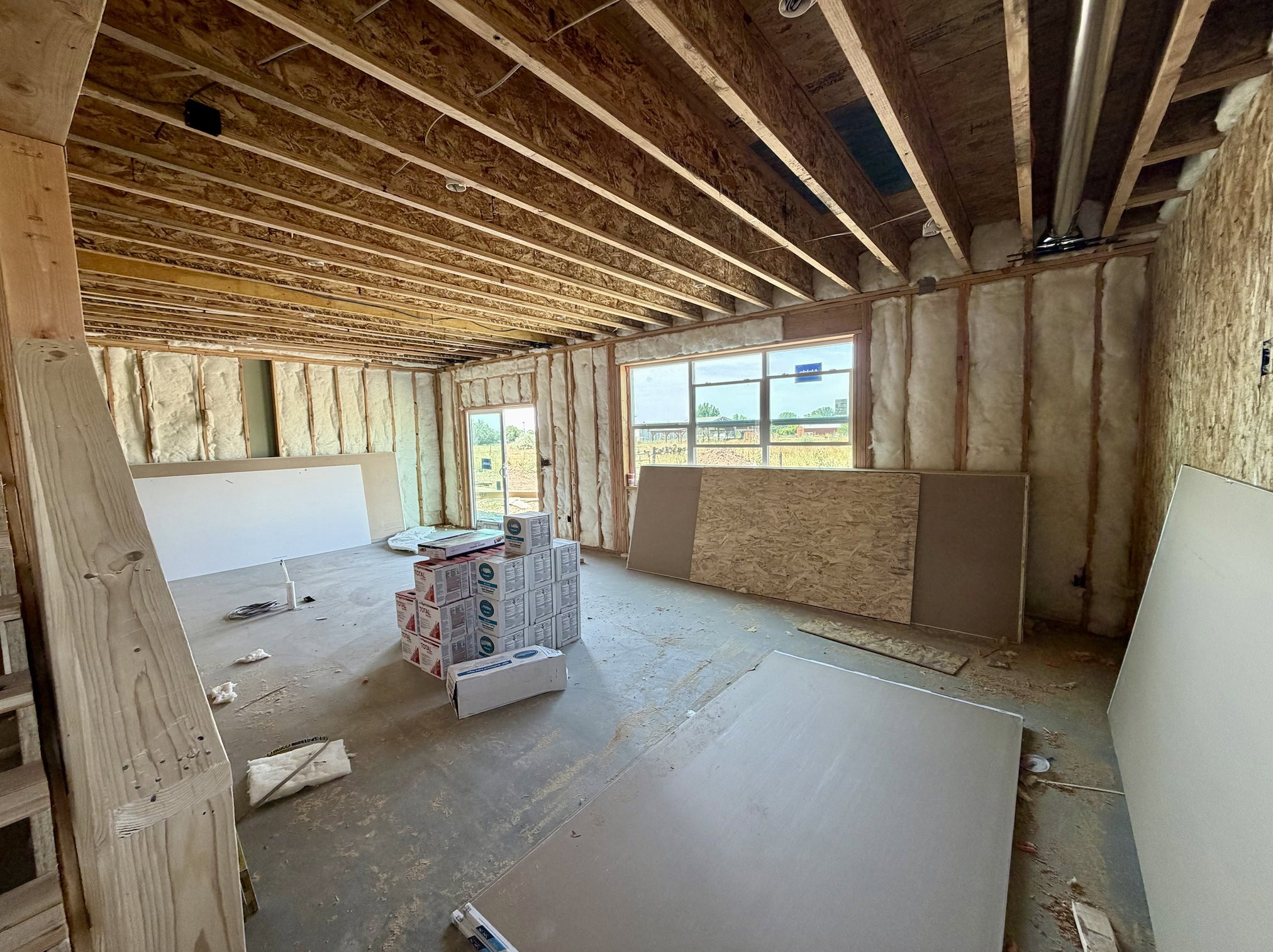 Unfinished interior space with exposed ceiling joists and wall studs