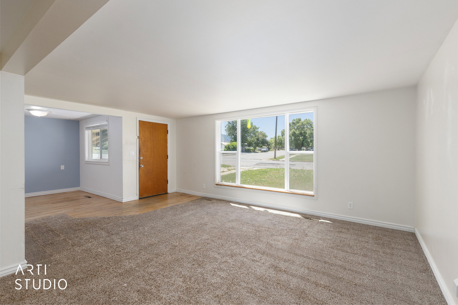 Bright living area with large picture windows providing ample natural light