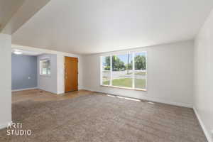 Bright living area with large picture windows providing ample natural light