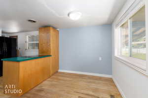 Kitchenette area featuring wood-finish flooring and a light blue accent wall