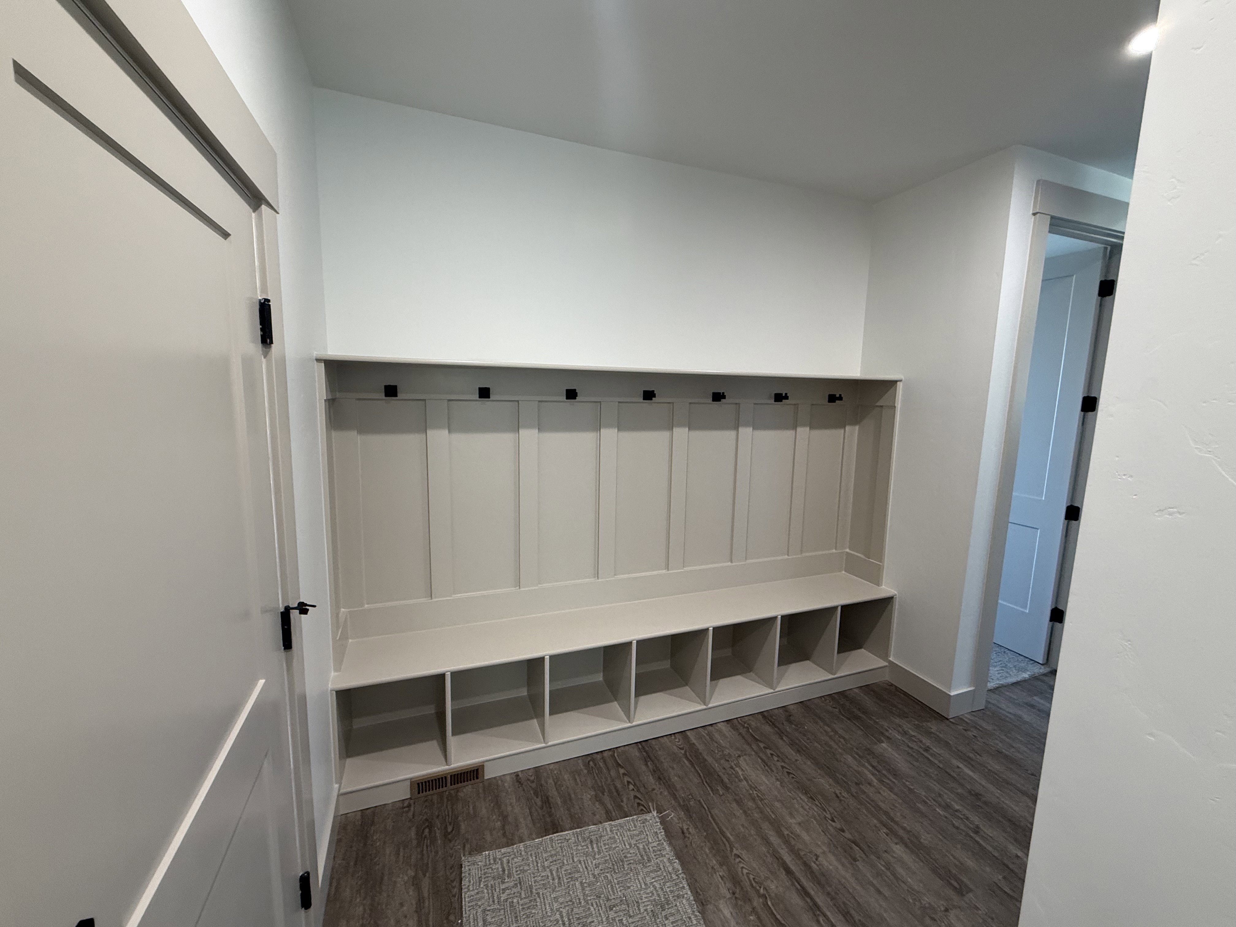 Built-in mudroom bench with storage cubbies and coat hooks