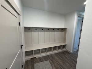 Built-in mudroom bench with storage cubbies and coat hooks