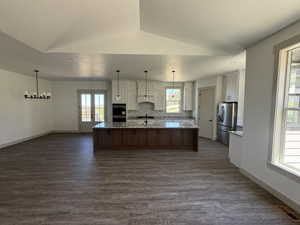 Open-concept kitchen and living area featuring wood-finish flooring
