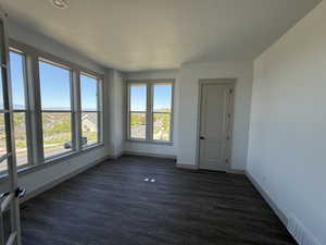Bright interior space featuring an expansive window wall and wood-finish flooring