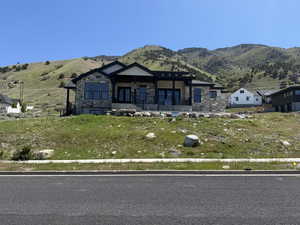Contemporary stone and stucco facade with a covered front porch