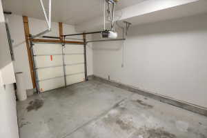 Interior garage featuring a paneled garage door and concrete flooring