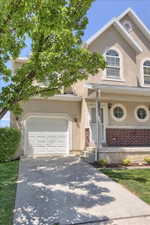 Stucco exterior with brick accents and white trim