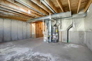 Unfinished basement featuring exposed wood ceiling joists and concrete walls
