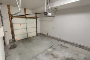 Single-bay garage with a concrete floor and white walls