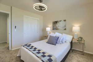 Bedroom featuring plush carpet flooring and neutral wall tones