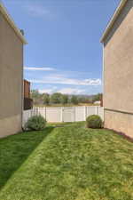 Private backyard featuring a well-maintained lawn and perimeter fencing