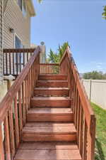 Wood-finish deck stairs with railings providing access to the property's exterior