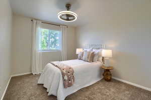 Bedroom featuring light tan walls and plush brown carpeting