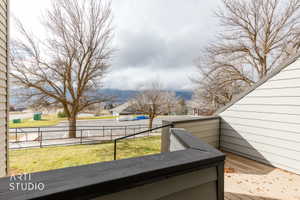 Outdoor deck featuring composite decking and railing, with a backdrop of distant mountains