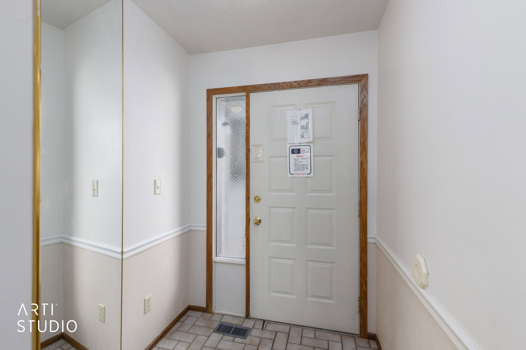 Entryway featuring a paneled door with wood-finish trim and an adjacent full-length sidelight