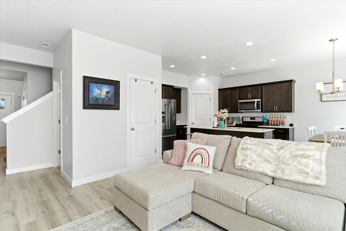 Open-concept living area featuring light wood-finish flooring and neutral wall tones