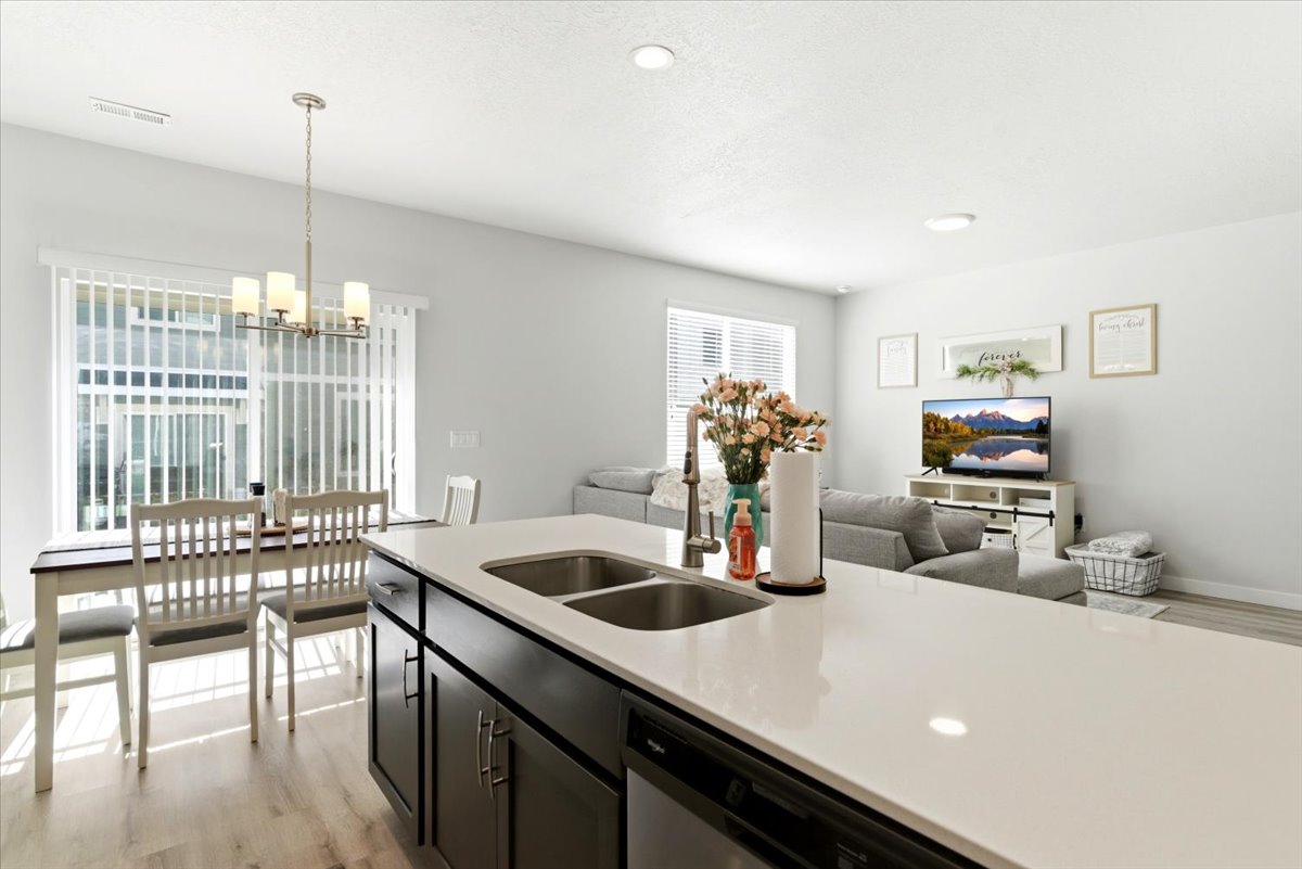 Kitchen island featuring a dual stainless steel sink and light-toned countertop