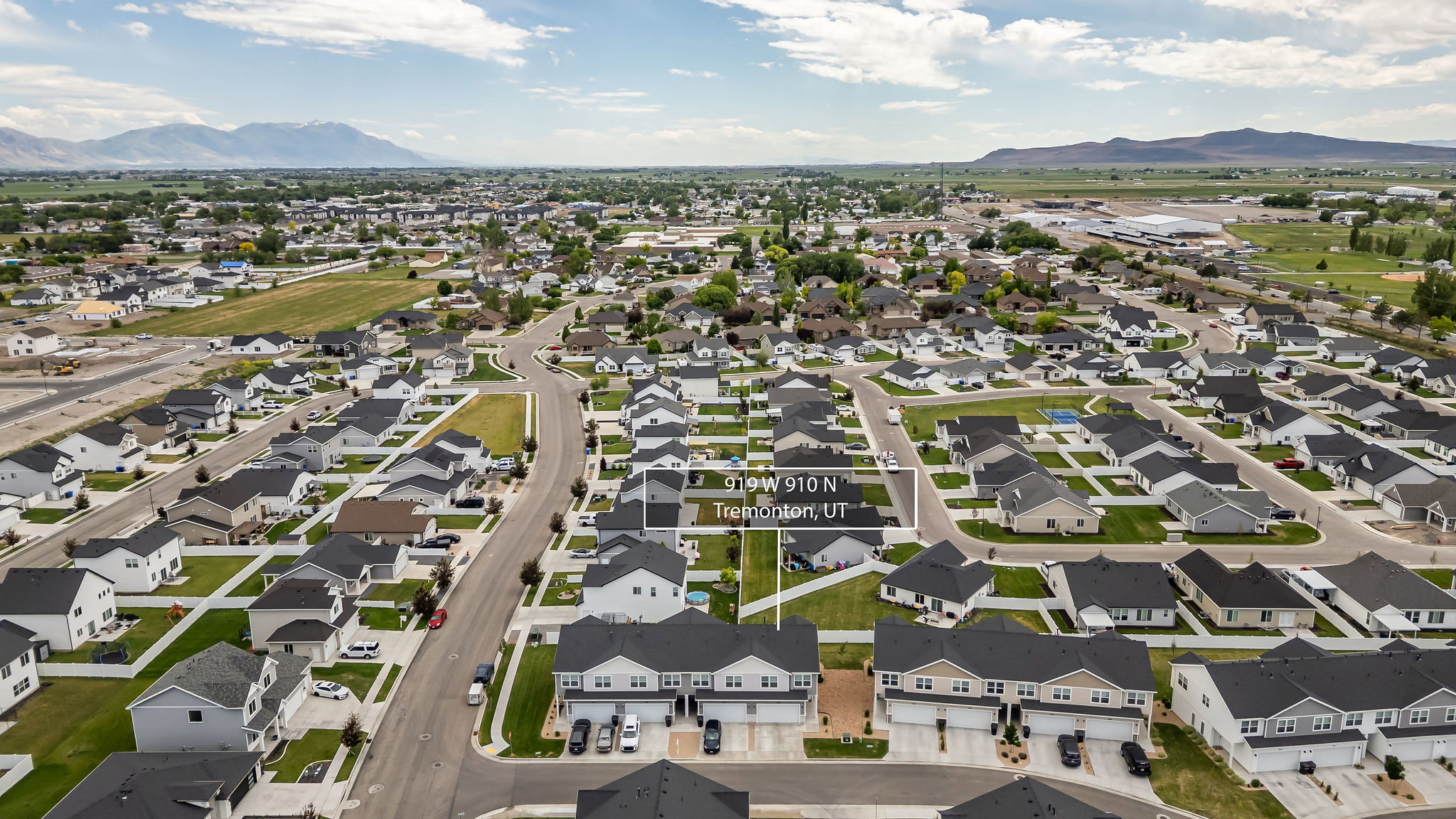 Aerial perspective showcasing a residential neighborhood with a mountain backdrop