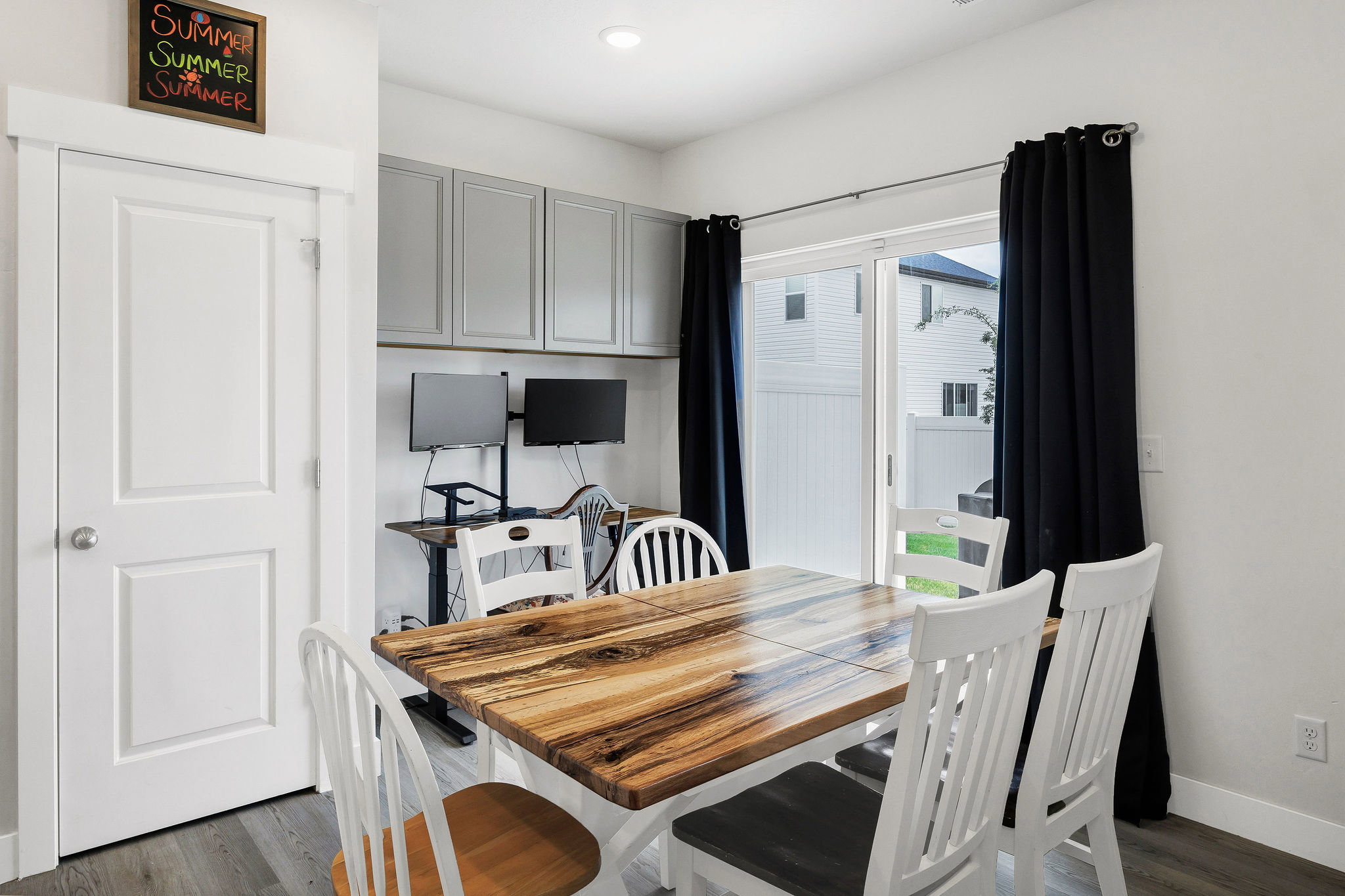 Dining area featuring wood-finish flooring, a glass sliding door, and recessed lighting
