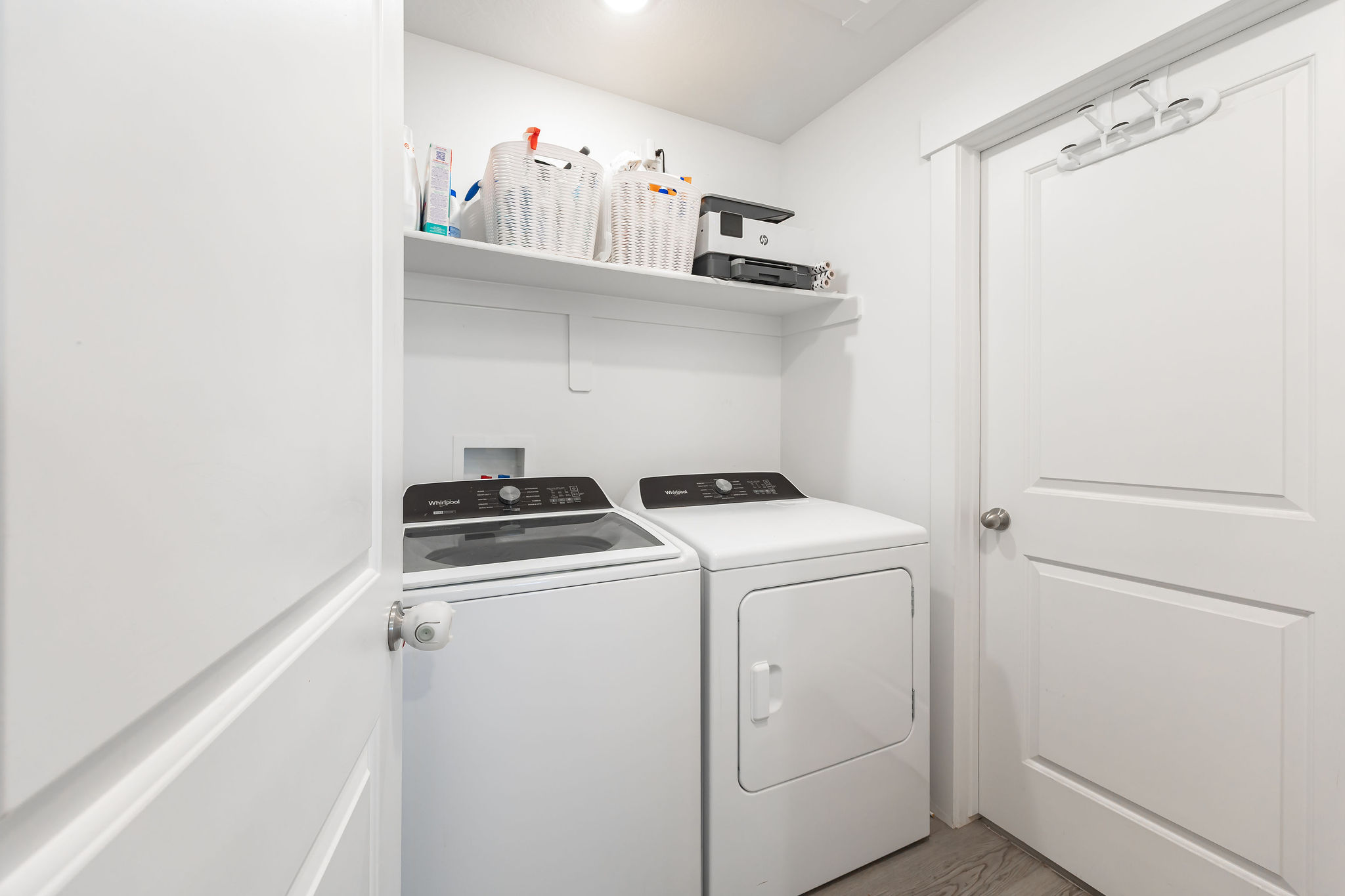 Dedicated laundry area featuring a white top-load washing machine and a white front-load dryer