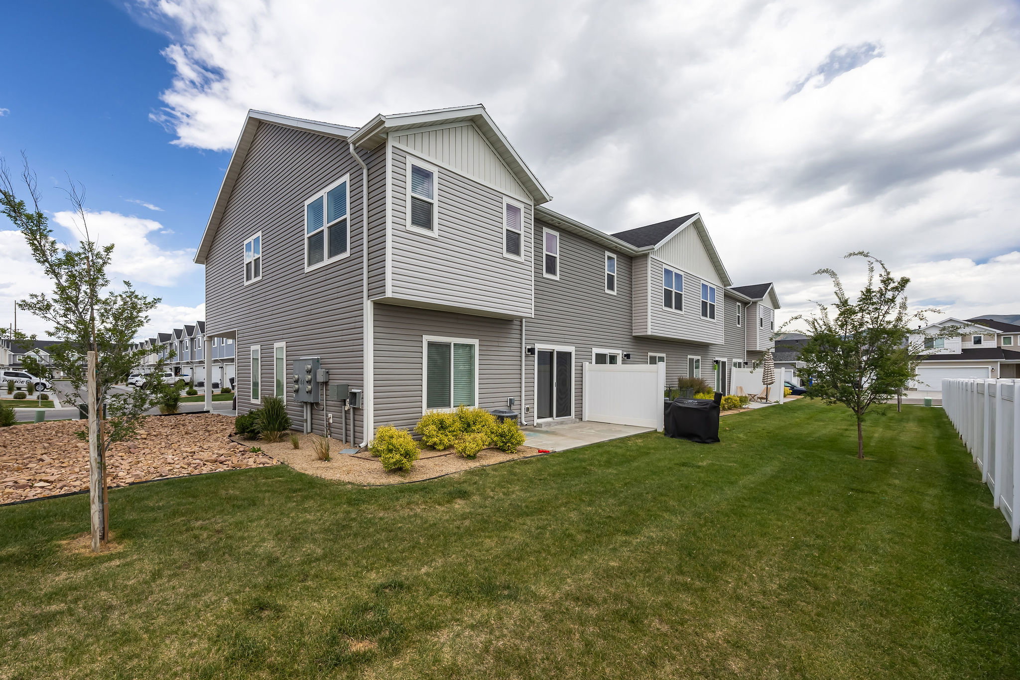 Expansive backyard featuring a manicured lawn and a privacy fence