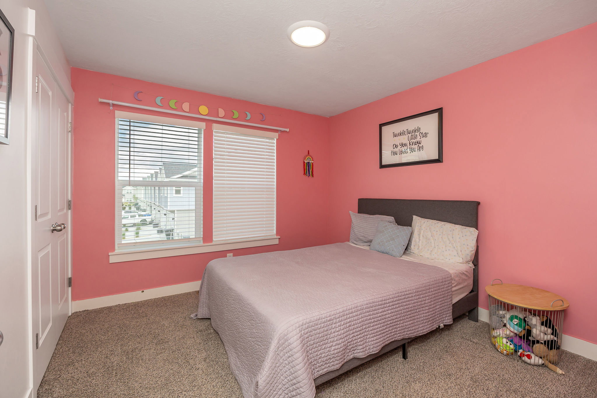 Carpeted room with a ceiling-mounted light fixture