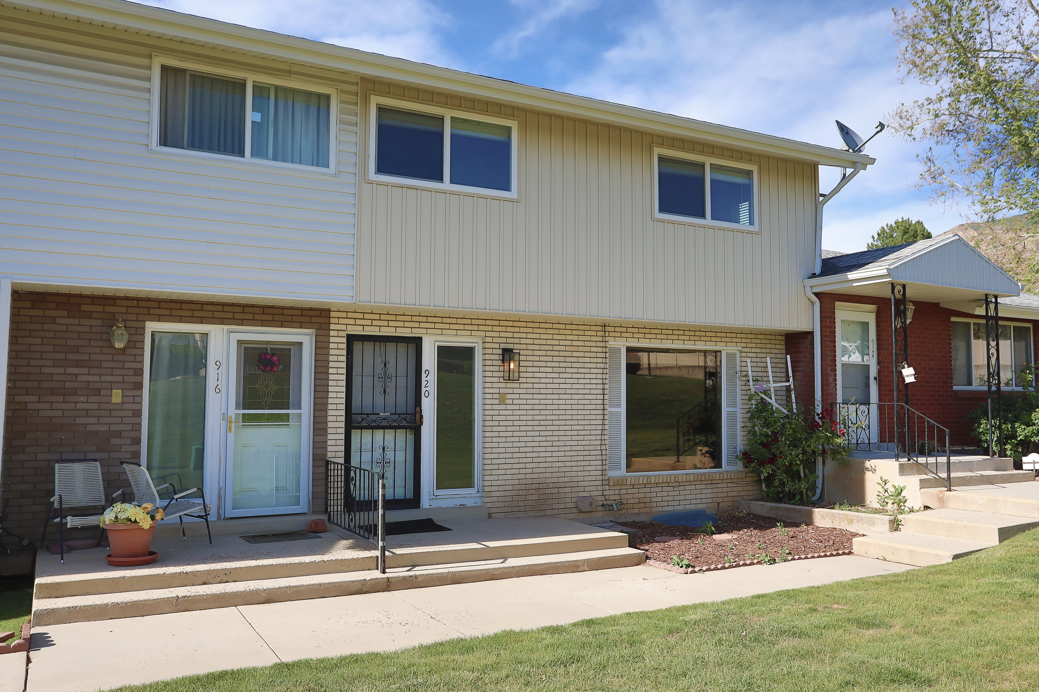 Two-story residence featuring a combination of brick and vertical siding