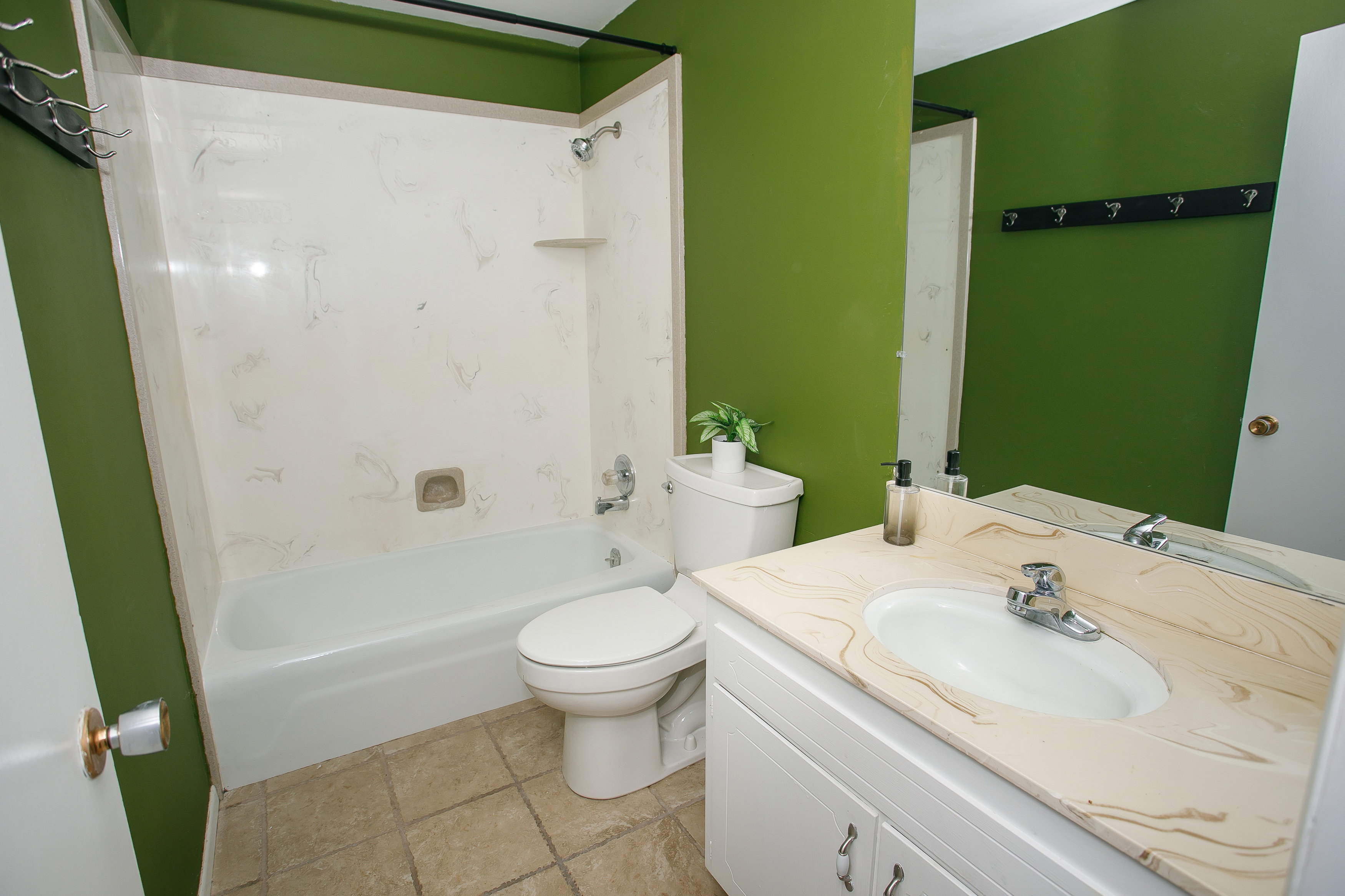Bathroom featuring a white vanity with a tan patterned countertop and an integrated sink