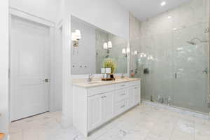 White marble-look tile flooring with a dual vanity featuring light-colored countertops, undermount sinks, and brushed nickel fixtures