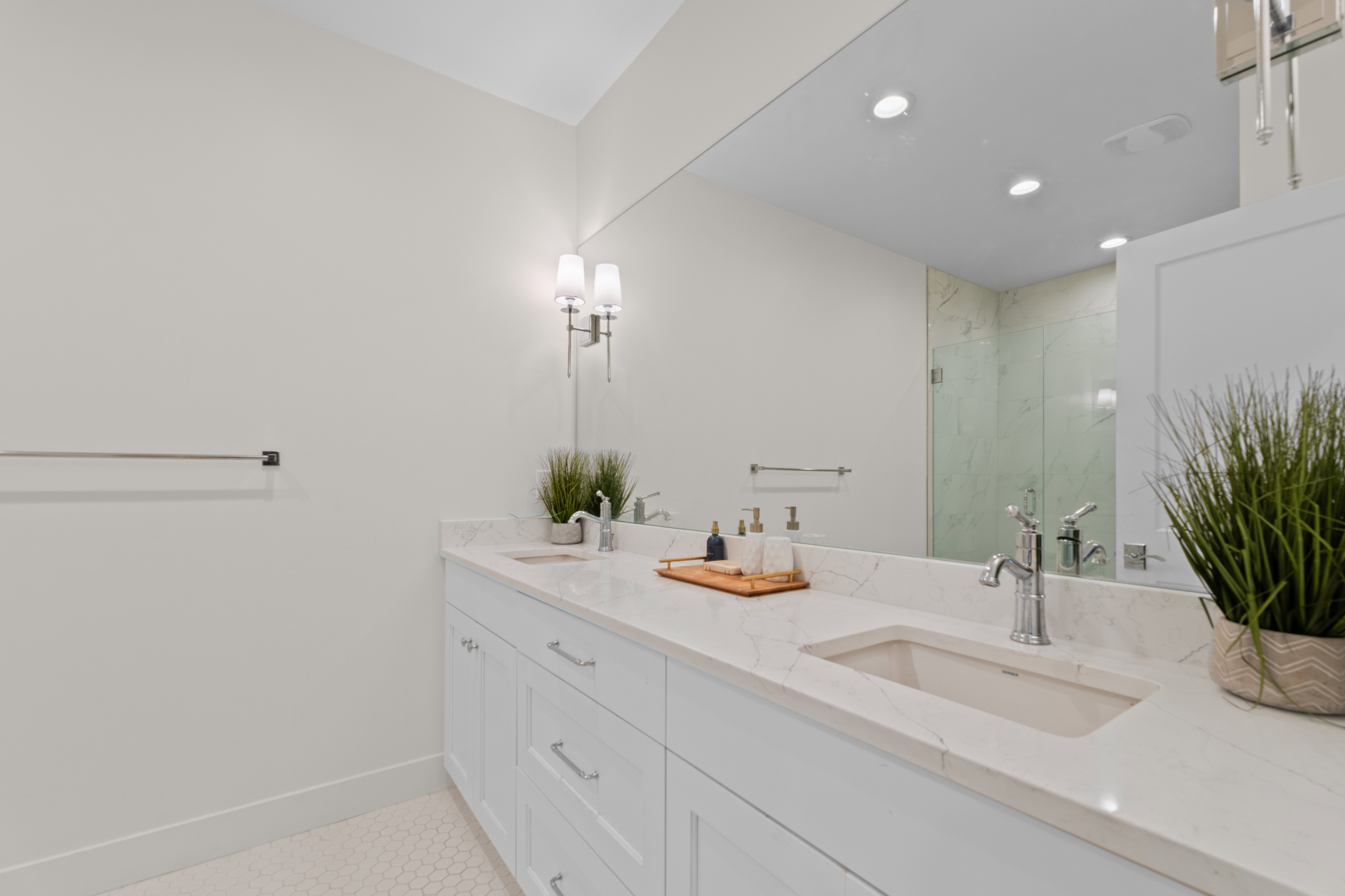 Double vanity with a light-colored countertop, undermount sinks, and chrome fixtures