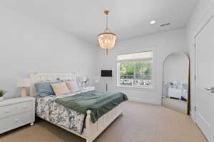 Spacious interior room with white walls and neutral carpet