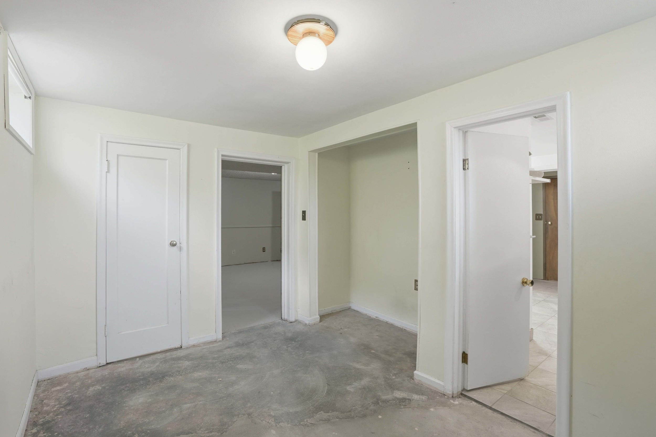 Room featuring light-colored walls and a concrete floor
