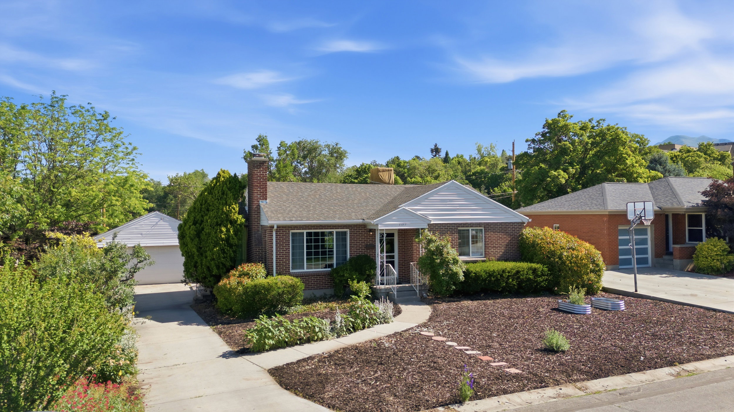 Brick exterior with a gabled roof and a prominent brick chimney
