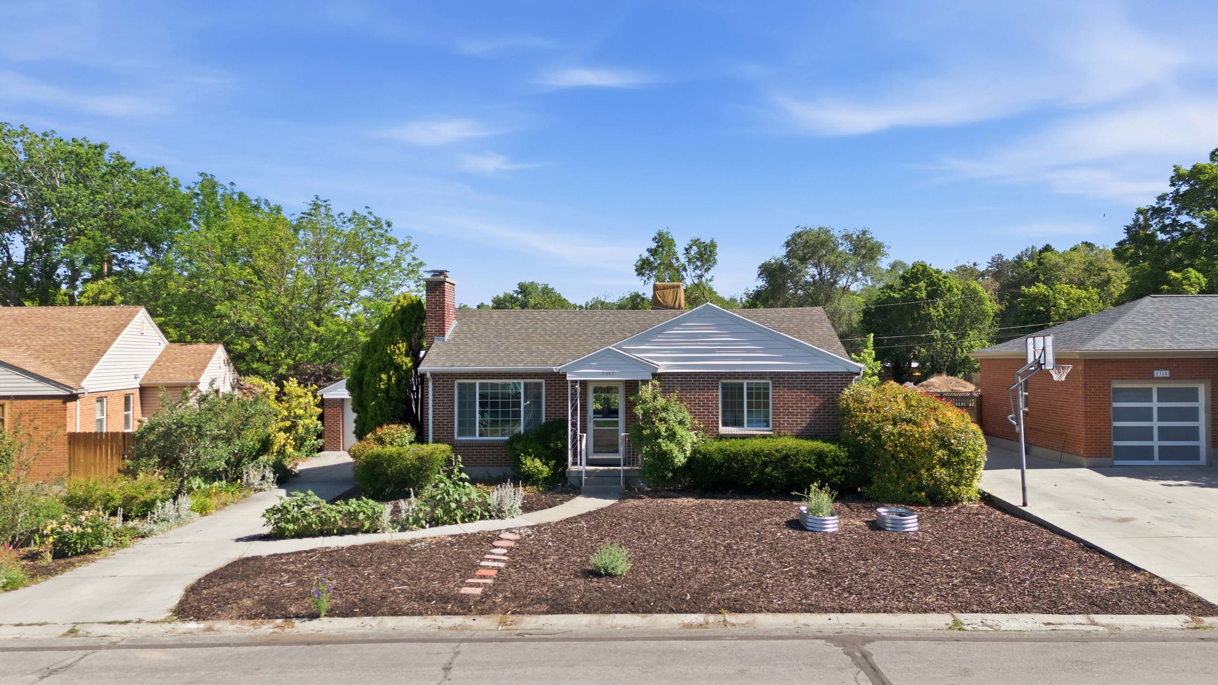 Brick exterior featuring a gabled roof and covered front entry