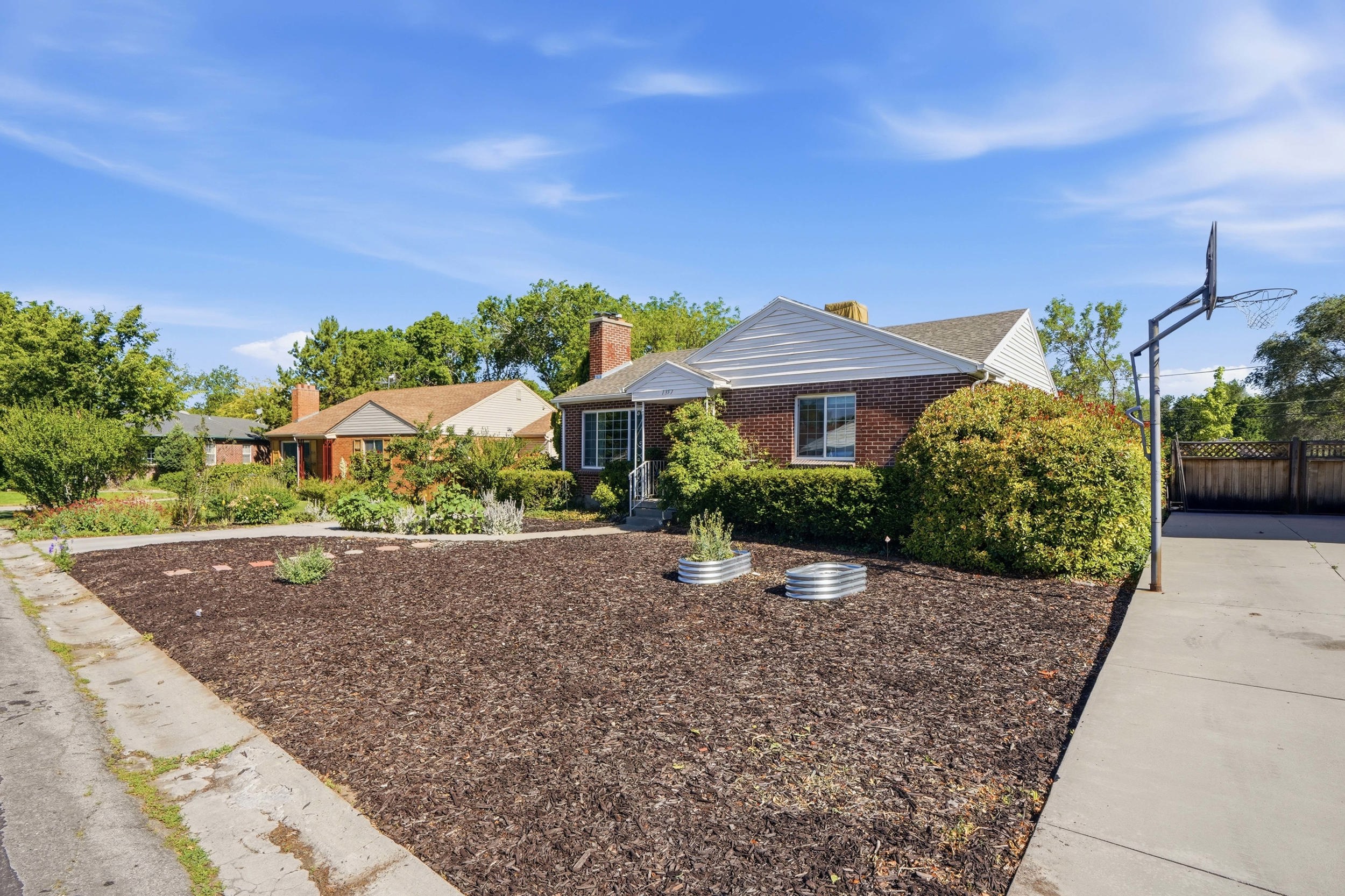 Brick exterior with white siding accents and a pitched roofline