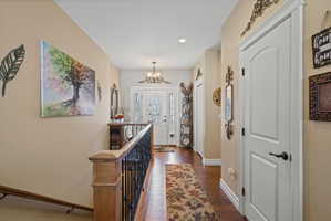 Inviting entryway featuring a white paneled front door with decorative glass, flanked by coordinating sidelights and a transom window