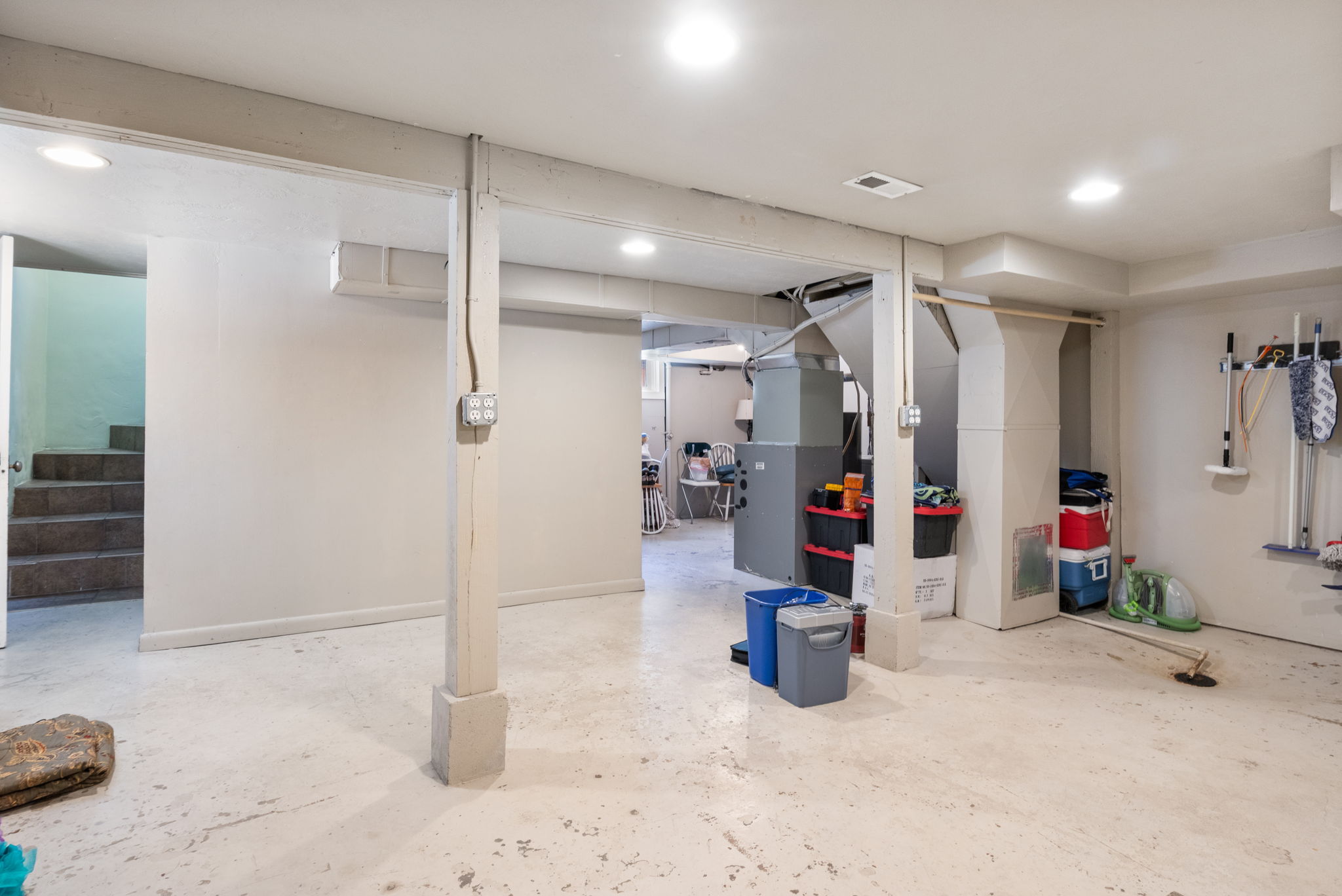 Spacious lower level with painted concrete flooring and recessed lighting