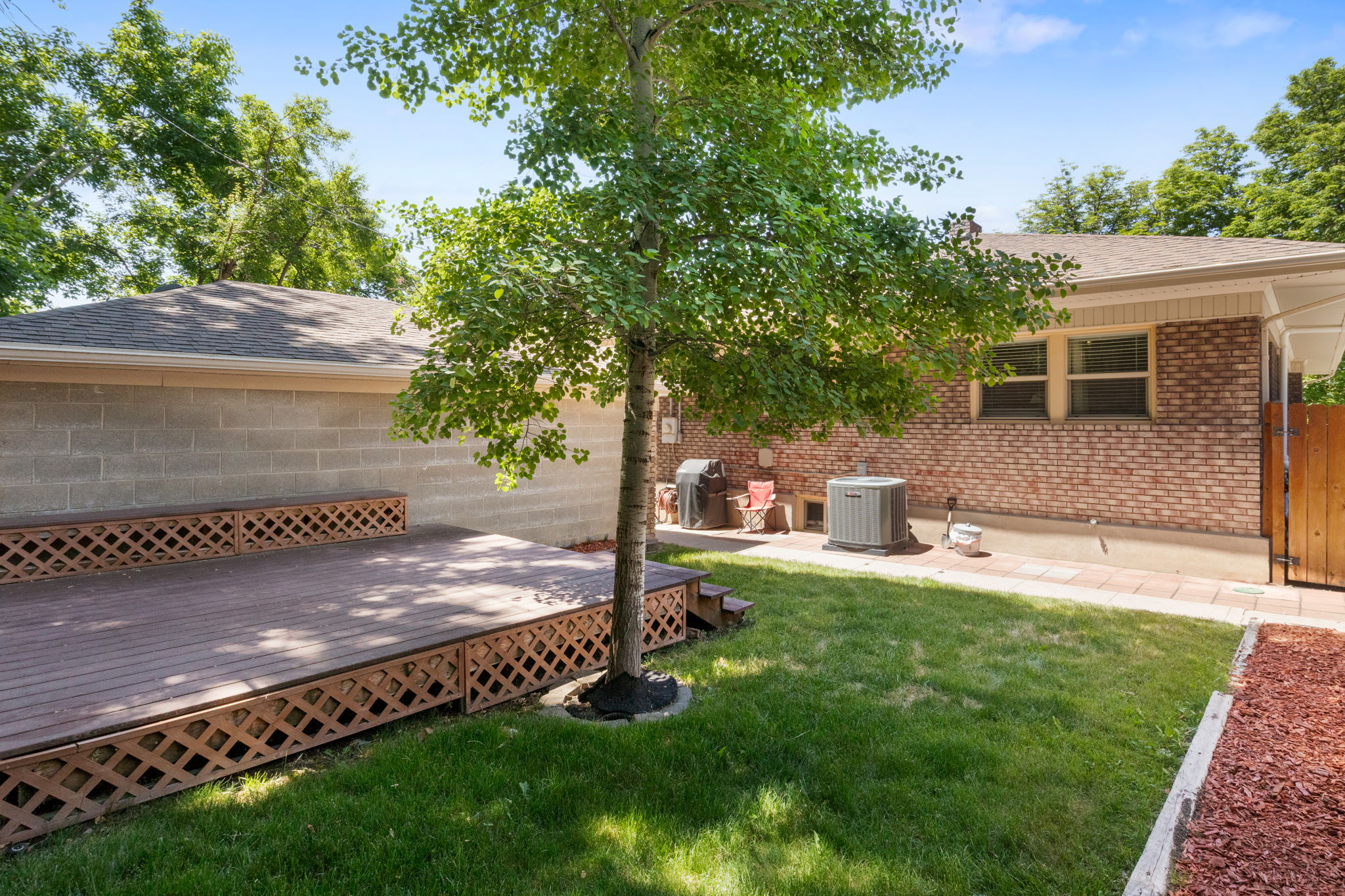 Expansive outdoor deck with lattice skirting and integrated step