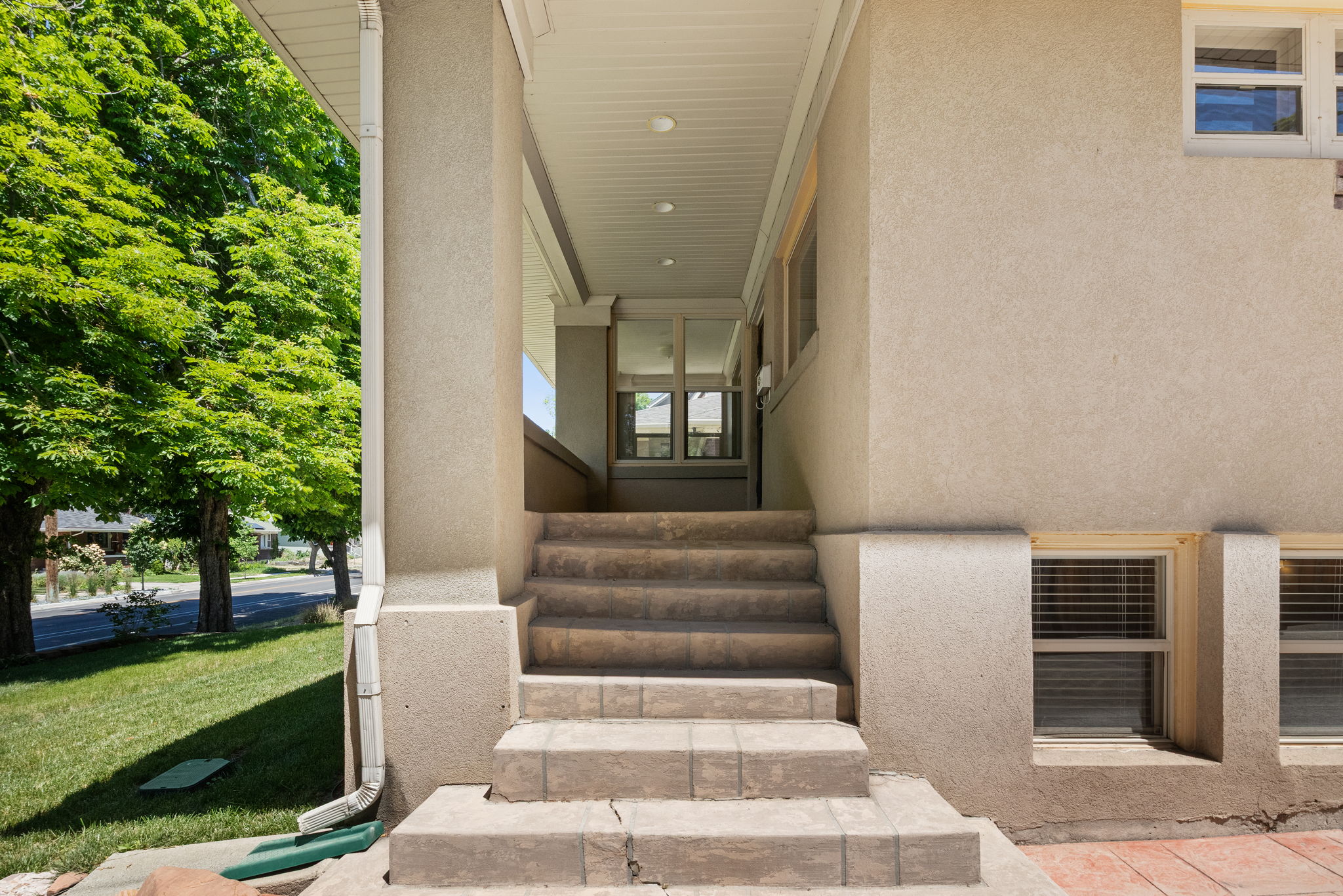 Stucco exterior with a covered porch entry