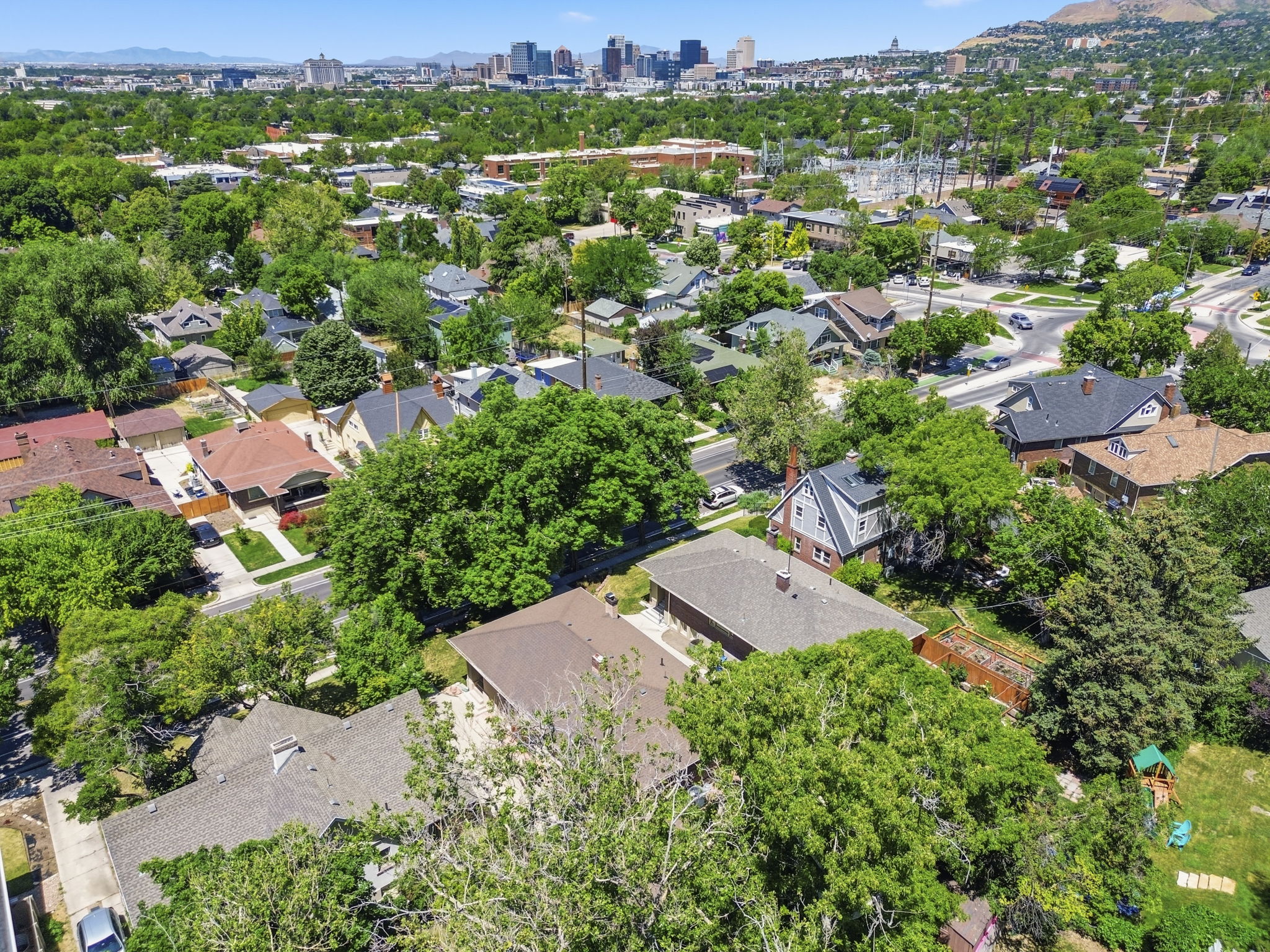 Aerial perspective of a verdant neighborhood with established trees and residential properties