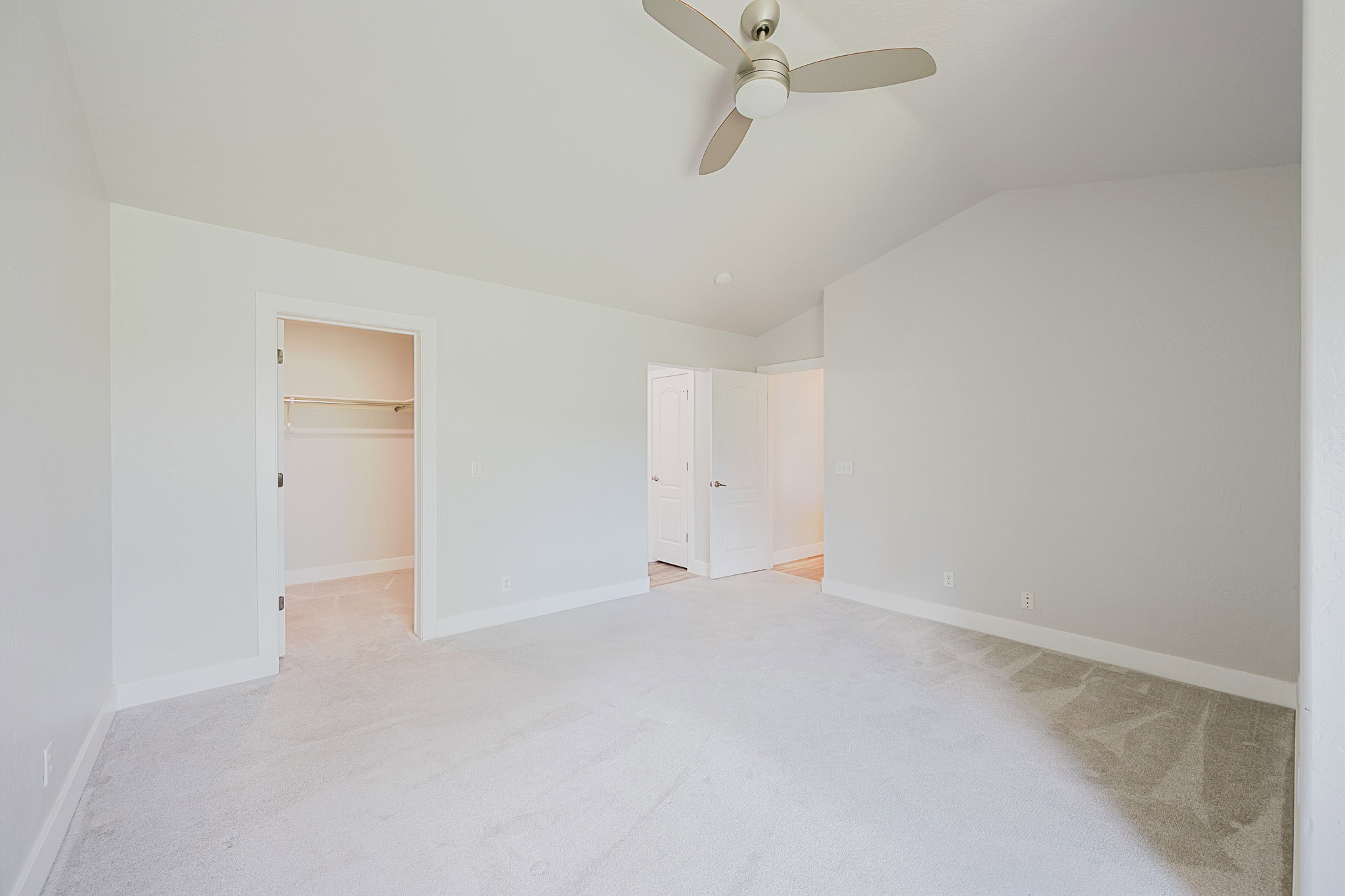 Primary bedroom looking toward walk-in closet and ensuite bath.
