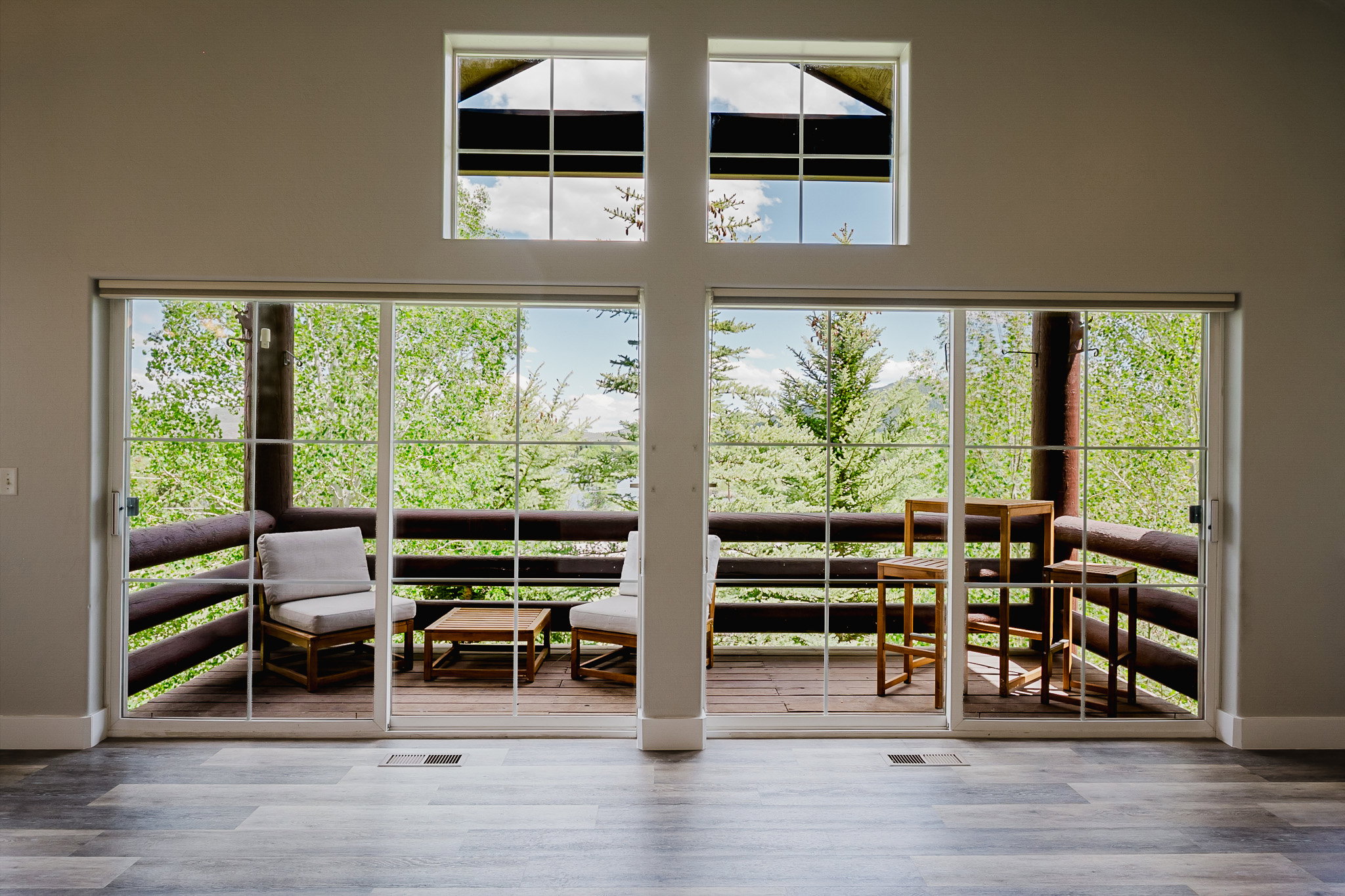 Side by side sliders plus windows near vaulted ceiling bring in lots of natural light and provides great views.